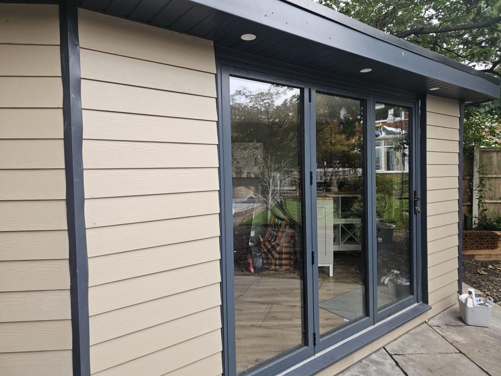 cream and black modern garden room with bi fold doors