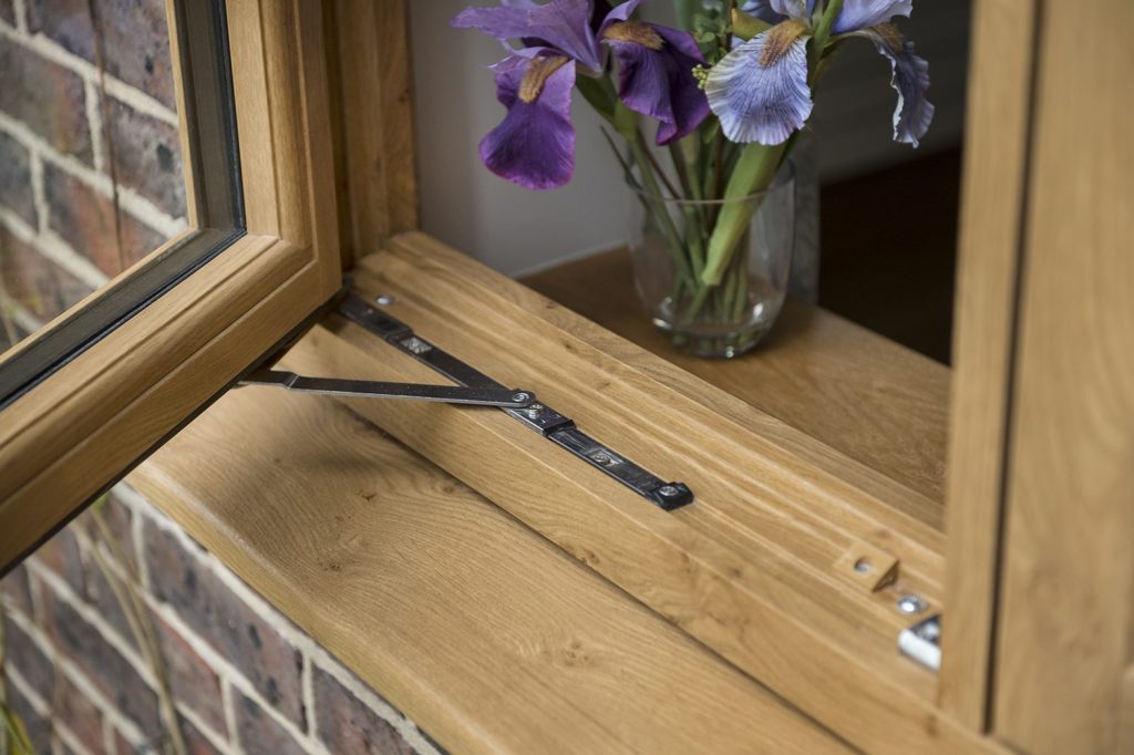 A stylish timber effect window featuring a flower vase on the sill, enhancing the home's inviting atmosphere.
