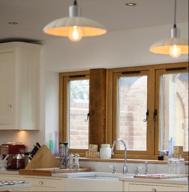 A modern kitchen featuring a sink and two stylish pendant lights, part of the residence collection.